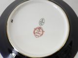 a black and white plate with a red stamp on it