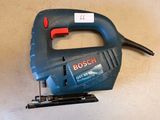 an image of a corded jig saw sitting on top of a table