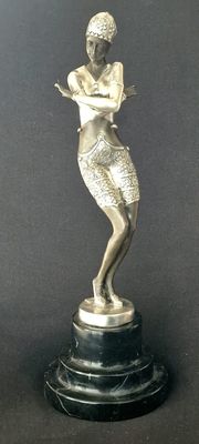 silver statue of a woman on a marble base