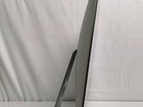 a laptop computer sitting on a stand on a white surface