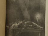 an old book with a drawing of a woman laying on a bed