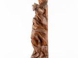 a wooden sculpture of a woman holding a flower in her hand
