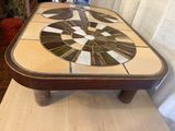 a coffee table with a mosaic design on top of it