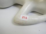 a white mannequin sitting on a table with a price tag on it