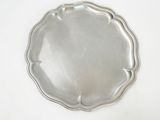 a silver plate on a white table with a white background