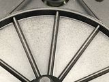 a black and white photo of a wheel on a table