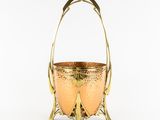 an antique brass basket with handles and handles on a white background