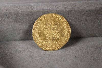 an image of a gold coin sitting in a velvet box