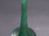 a green vase that is sitting on a table