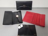 three black and red leather wallets and a red and black purse