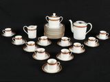 many cups and saucers arranged in a circle on a table