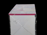 a white box with a pink lid on a black background