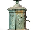 a green fountain with a statue on top of it