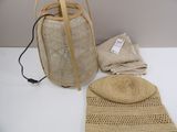 un sac en paille et un chapeau de paille posés sur une table blanche
