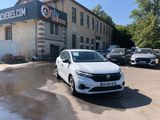 a white car parked in front of a building