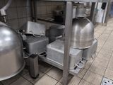 several pots and pans are sitting on a table in a kitchen