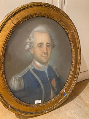 portrait of a man in a blue uniform in a gold frame
