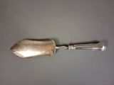 a silver spoon with a handle on top of a table