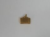 an image of a gold plated pendant with a suitcase on it