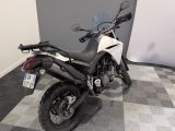 a picture of a white and black motorcycle parked on a checkered floor