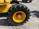 a yellow tractor that is parked in a parking lot