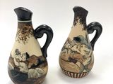 two vases that are sitting side by side on a white surface