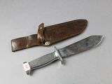 a knife that is sitting on a table next to a knife