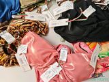many different types of clothing on display on a table
