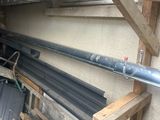 a pile of metal pipes and a bucket of hay in the back of a truck
