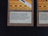 two cards with a picture of a sword on them