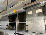 stainless steel cabinets in a commercial kitchen with a lot of clutter