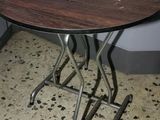 a small table with a wooden top sitting on the floor