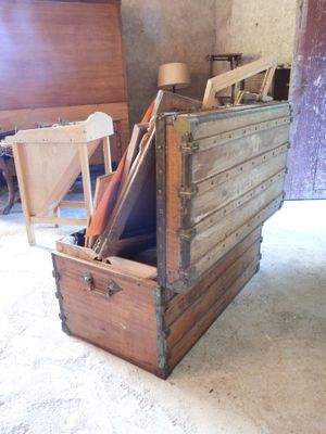 a large wooden box with a lot of items inside of it