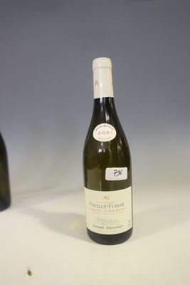 a bottle of wine sitting on a table next to a bottle of wine
