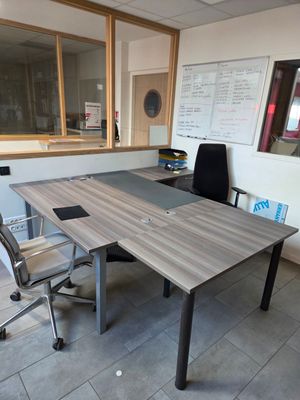 a desk with a chair and a computer on it in a room