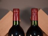 two bottles of wine that are sitting on a table