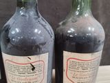 three bottles of wine sitting on top of a table next to each other