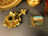 a gold plate with a picture on it next to other items