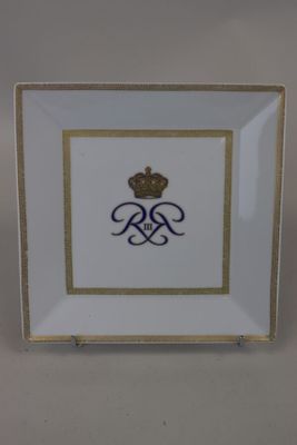 a close up of a plate with a crown on it