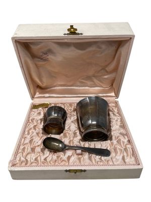 two cups and spoons in a box on a table