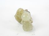 a small statue of a man holding a glass ball