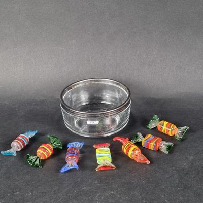 a small glass bowl with candy in it on a table