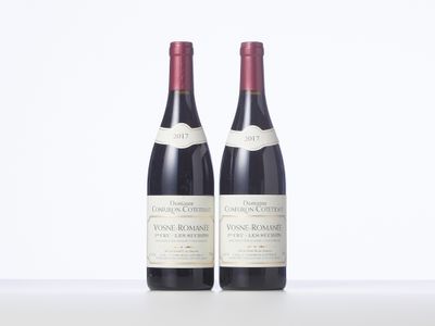 two bottles of wine sitting next to each other on a table