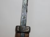a close up of a knife on a wooden stand