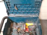 a blue tool box with tools in it sitting on the floor
