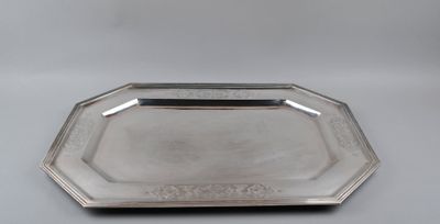 a silver tray on a table with a handle