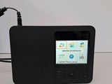 a small black radio that is connected to a charger