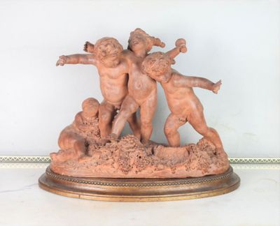 a statue of three children playing with a ball on a table
