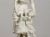 statue of a woman and two children on a table