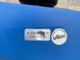 a close up of a blue bike with a sticker on it